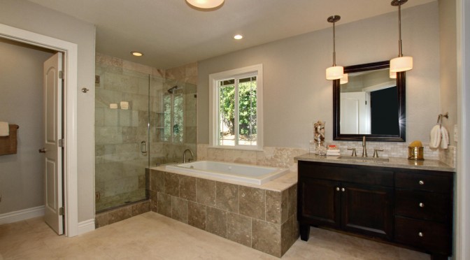 Frameless shower glass, floor to ceiling 12x24 Alabastrino shower surround tile. Brushed Nickel hardware throughout