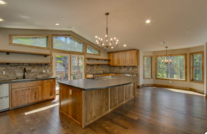 Rustic kitchen, hickory cabinets, leathered black granite counters, wrought iron fixtures and lighting, real rock veneer back Splash, clerestory windows, hard wood flooring